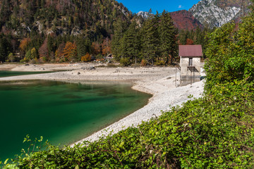 Fototapeta na wymiar Predil lake dressed in autumn colors. Magical Tarvisio