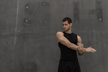 Strong muscular, sporty man warming up, getting ready for training
