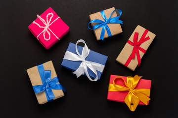 A lot of gift boxes on a black background. Holiday concept, New Year, Christmas, Birthday, Valentine's Day. Copy space. Flat lay, top view.