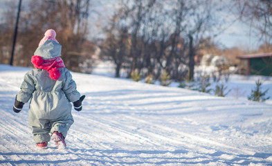 Fototapeta na wymiar Little Girl Walking In Cold Winter Day