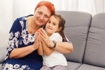 grandmother and her granddaughter holding hands.