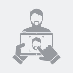 Tablet take a photo to a bearded guy