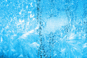 Abstract winter background - blue frozen window outdoors