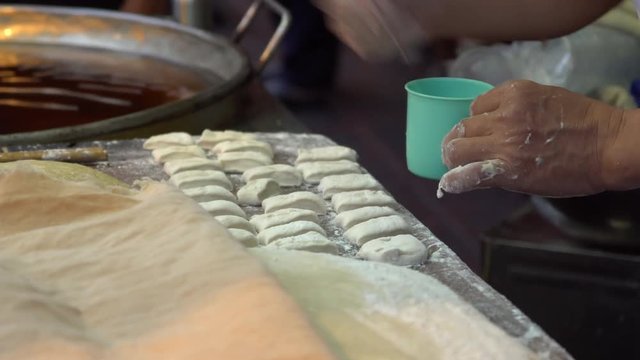 Chef preparing Fried Bread Stick, (youtiao, patongko, Banh Quay)