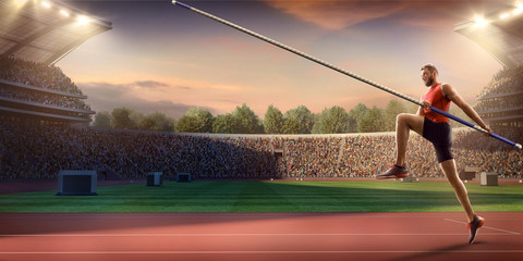 Young male pole vault athlete with pole bar. Men in sport clothes at athletic sport track in...