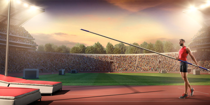 Young male pole vault athlete with pole bar. Men in sport clothes at athletic sport track in professional stadium