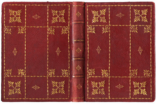Fototapeta Antique open book in textured red leather cover with floral and abstract embossed golden decorations, isolated on white
