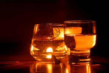 beautiful glasses in the flame of a candle