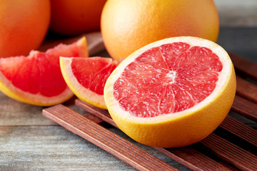 Fresh raw grapefruit (citrus x paradisi) on wooden background