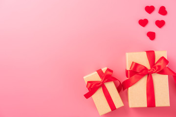 Giving present and celebration concept at Valentine's day, anniversary, mother's day and birthday surprise on pink background, copyspace, topview