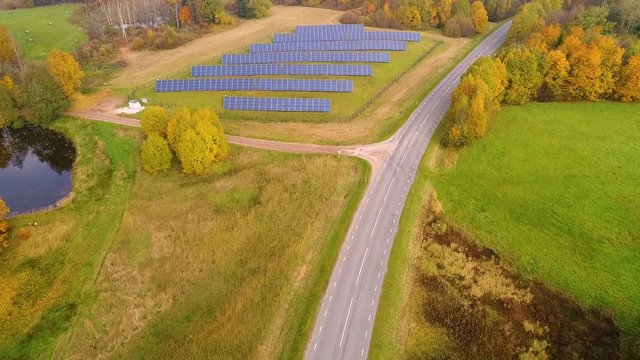 Aerial View Of Solar Panel Rows Near A Forest During Autumn, Estonia.