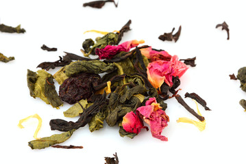 Dried black, green tea and fruit tea on white.