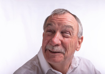 Laughing senior man on white background 