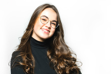 Fototapeta premium Portrait of a charming brunette girl with glasses on white background
