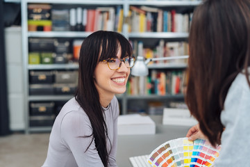 Happy young woman working in a design studio