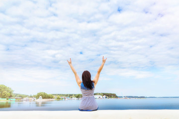 happy woman with arms raised up. Wonderful summer weather