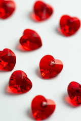 Red heart crystal on white paper, valentine's background
