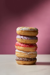 sweet glazed doughnuts on pink background