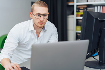 Dedicated young businessman working on a laptop