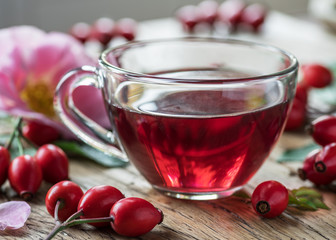 Rose hips with rose leaves isolated on a white background.