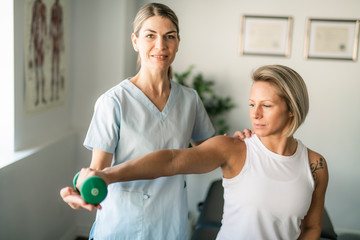 A Modern rehabilitation physiotherapy worker with woman client