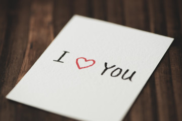 I love you greeting card on wooden table, valentine's background