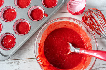 red velvet cake batter with ingredients and cupcake tin flat lay
