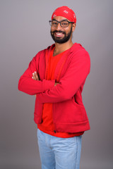 Portrait of young handsome Indian man wearing red shirt