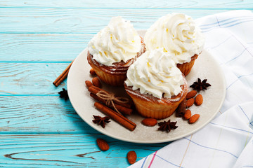 Christmas cakes with whipped cream on a wooden background. Place for text. Top view.