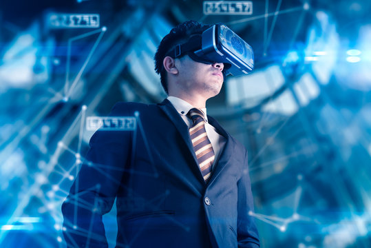 The abstract double exposure image of businessman using a smart glasses or vr glasses overlay with virtual hologram image. the concept of communication, internet of things and future life.
