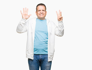 Fototapeta premium Middle age arab man wearing sweatshirt over isolated background showing and pointing up with fingers number eight while smiling confident and happy.