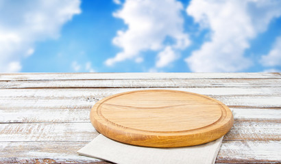 pizza board and paper napkin on wooden table