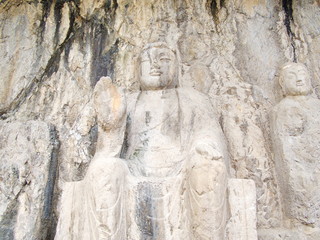 Fototapeta na wymiar Luoyang Longmen grottoes. Buddha and the stone caves and sculptures in the Longmen Grottoes in Luoyang, China. Taken in 14th October 2018