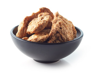 Bowl of soya chunks on white background