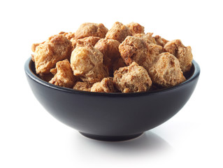 Bowl of soya chunks on white background