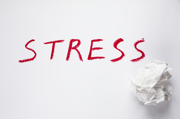 stress inscription in red letters on a sheet of paper, business still life