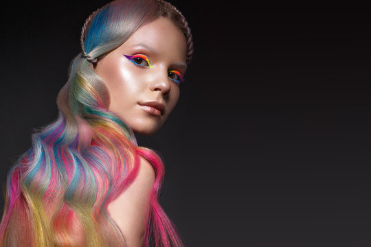 Beautiful girl with multi-colored hair and creative make-up and hairstyle. Beauty face.