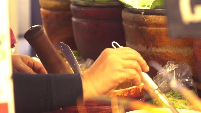 Chef preparing Som Tum, Thai Papaya salad.