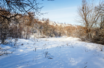 Sunny frosty day in the industrial area of the quarry. Open development.