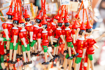19 OCTOBER 2018, FLORENCE, ITALY: pinocchio puppets toys for sale at touristic shop as souvenirs...