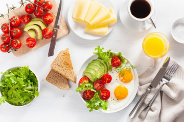 healthy breakfast flat lay. fried eggs, avocado, tomato, toasts and coffee