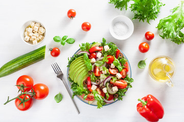 greek style avocado tomato salad with feta cheese, olives, cucumber, onion, lettuce
