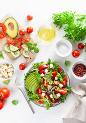 greek style avocado tomato salad with feta cheese, olives, cucumber, onion, lettuce