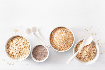 variaty of raw cereals for breakfast. Oatmeal flakes and steel cut, barley, chia seed. Healthy ingredients