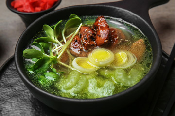 Tasty Chinese soup in bowl on table, closeup
