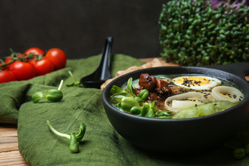 Tasty Chinese soup in bowl on table