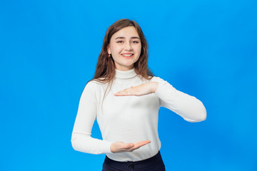 Young beautiful girl isolated on blue background