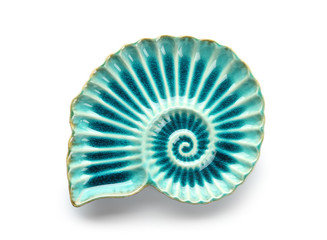 Stylish plate in shape of seashell on white background