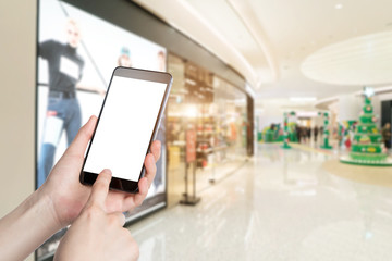 Using smartphone in a market or department store, closeup