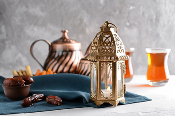 Fototapeta na wymiar Muslim lantern with dried dates on table